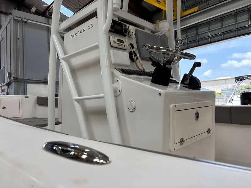 Slide: The Image of 2014 Andros Tarpon 26 boat console in a garage setting. - 10