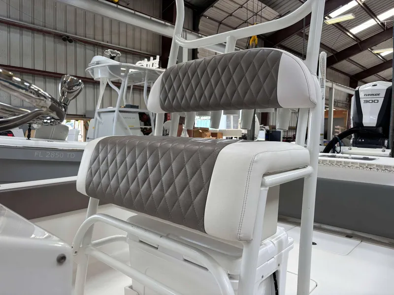 Slide: The Image of Andros Tarpon 26 boat seat, 2014 model, featuring diamond-stitched upholstery in a warehouse setting. - 13
