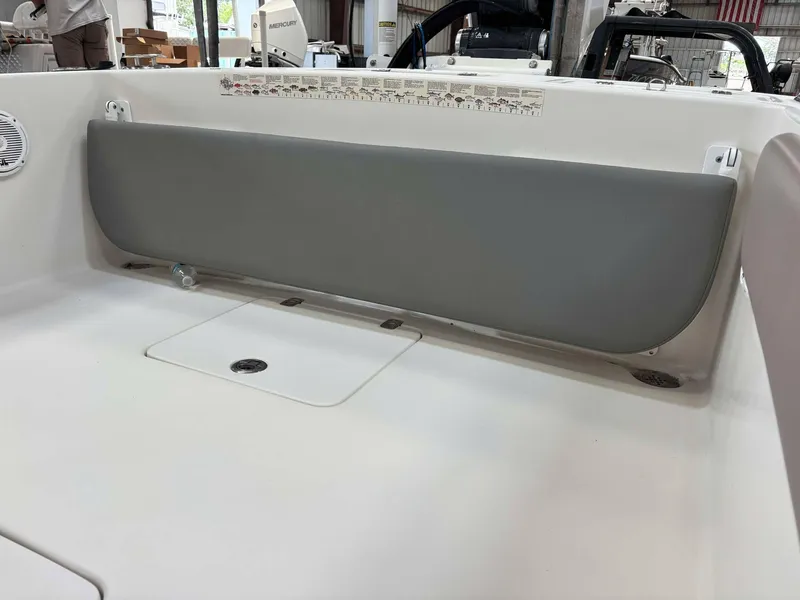 Slide: The Image of 2014 Andros Tarpon 26 boat interior with gray cushioned seating and storage compartment. - 15