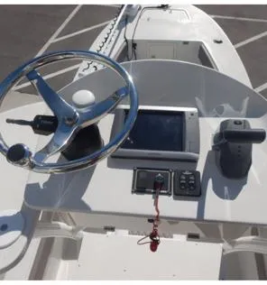 Slide: The Image of 2014 Andros Tarpon 26 boat dashboard with steering wheel and navigation controls. - 16