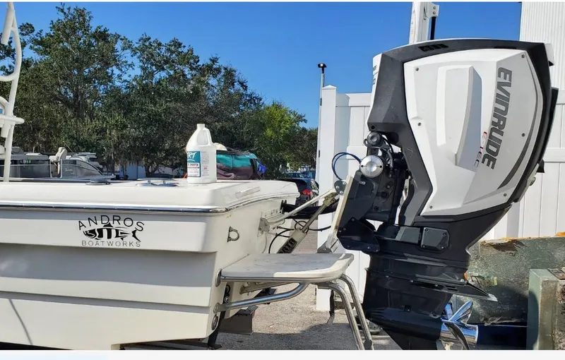 Slide: The Image of 2014 Andros Tarpon 26 boat with Evinrude outboard motor, parked outdoors. - 17