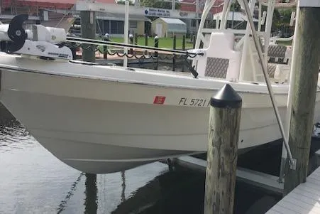 Slide: The Image of 2014 Andros Tarpon 26 boat docked at marina, side view. - 2