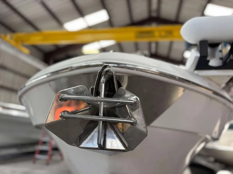 Slide: The Image of 2014 Andros Tarpon 26 boat with anchor in a warehouse setting. - 4