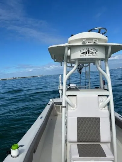 Slide: The Image of 2014 Andros Tarpon 26 boat on open water under clear blue sky. - 7