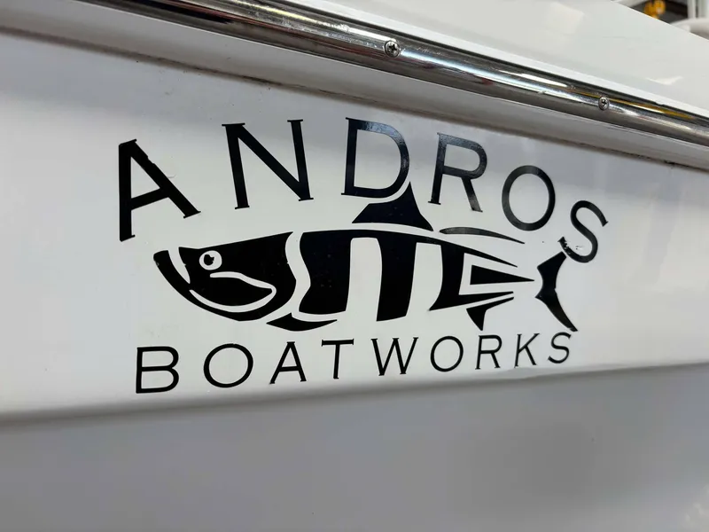 Slide: The Image of 2014 Andros Tarpon 26 boat logo with fish design on white surface. - 3