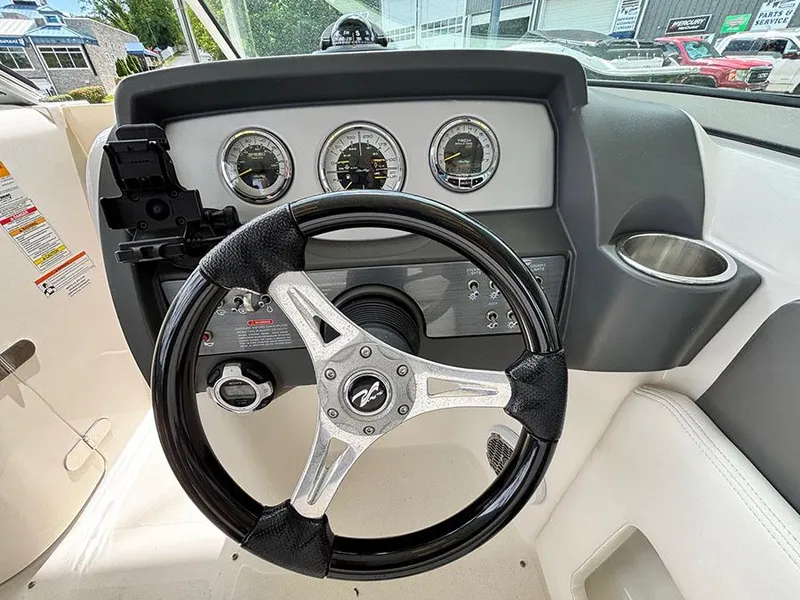 Slide: The Image of Steering wheel and dashboard of a 2011 Sea Ray 240 Sundeck boat. - 10