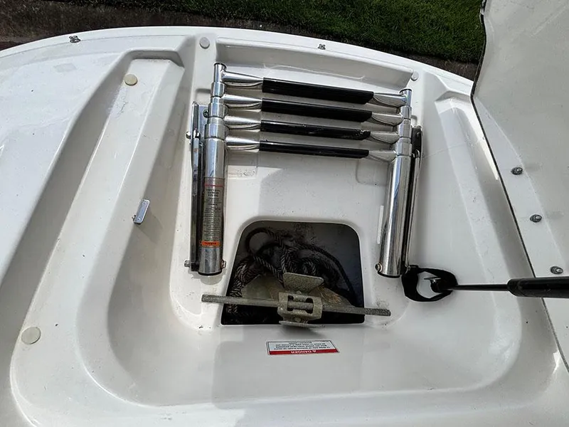 Slide: The Image of 2011 Sea Ray 240 Sundeck boat ladder and anchor storage compartment. - 13