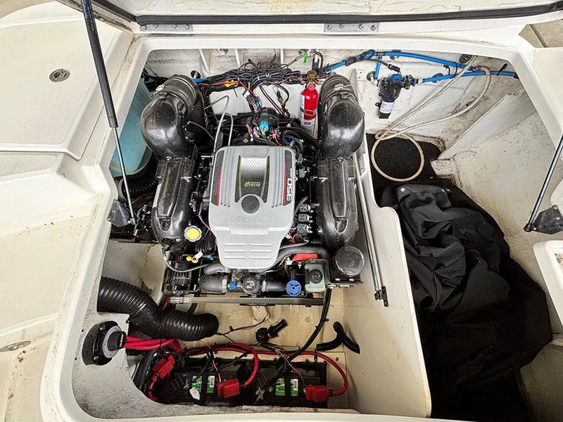 Slide: The Image of Engine compartment of a 2011 Sea Ray 240 Sundeck boat, featuring a well-maintained motor. - 15