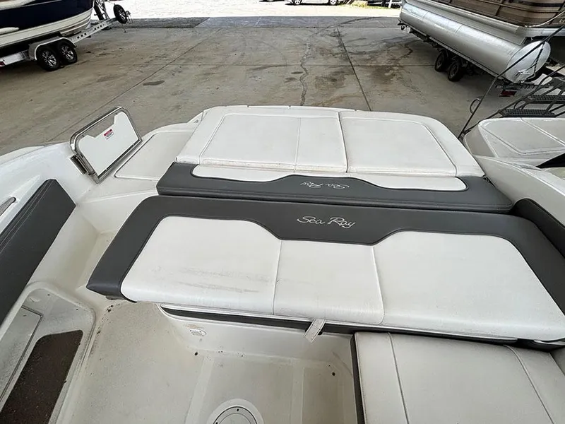 Slide: The Image of 2011 Sea Ray 240 Sundeck boat interior with white and gray seating. - 6
