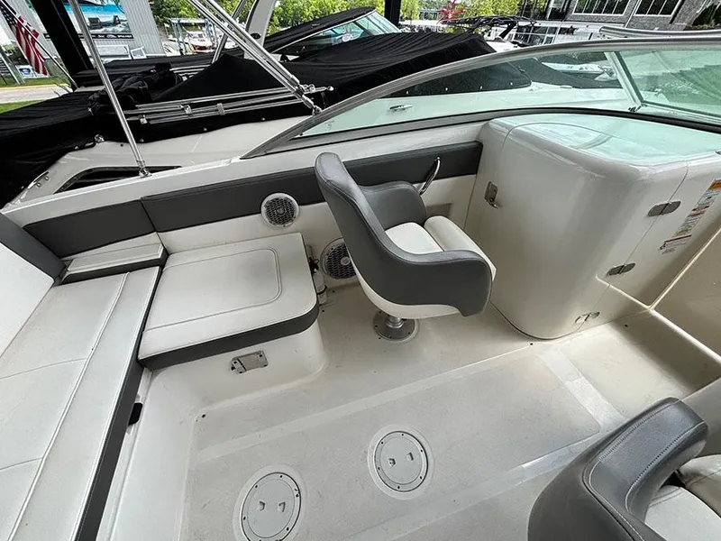 Slide: The Image of 2011 Sea Ray 240 Sundeck interior with seating and helm area. - 7