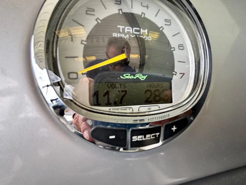 Slide: The Image of Tachometer of 2011 Sea Ray 240 Sundeck showing 11.7 volts and 289 hours. - 9