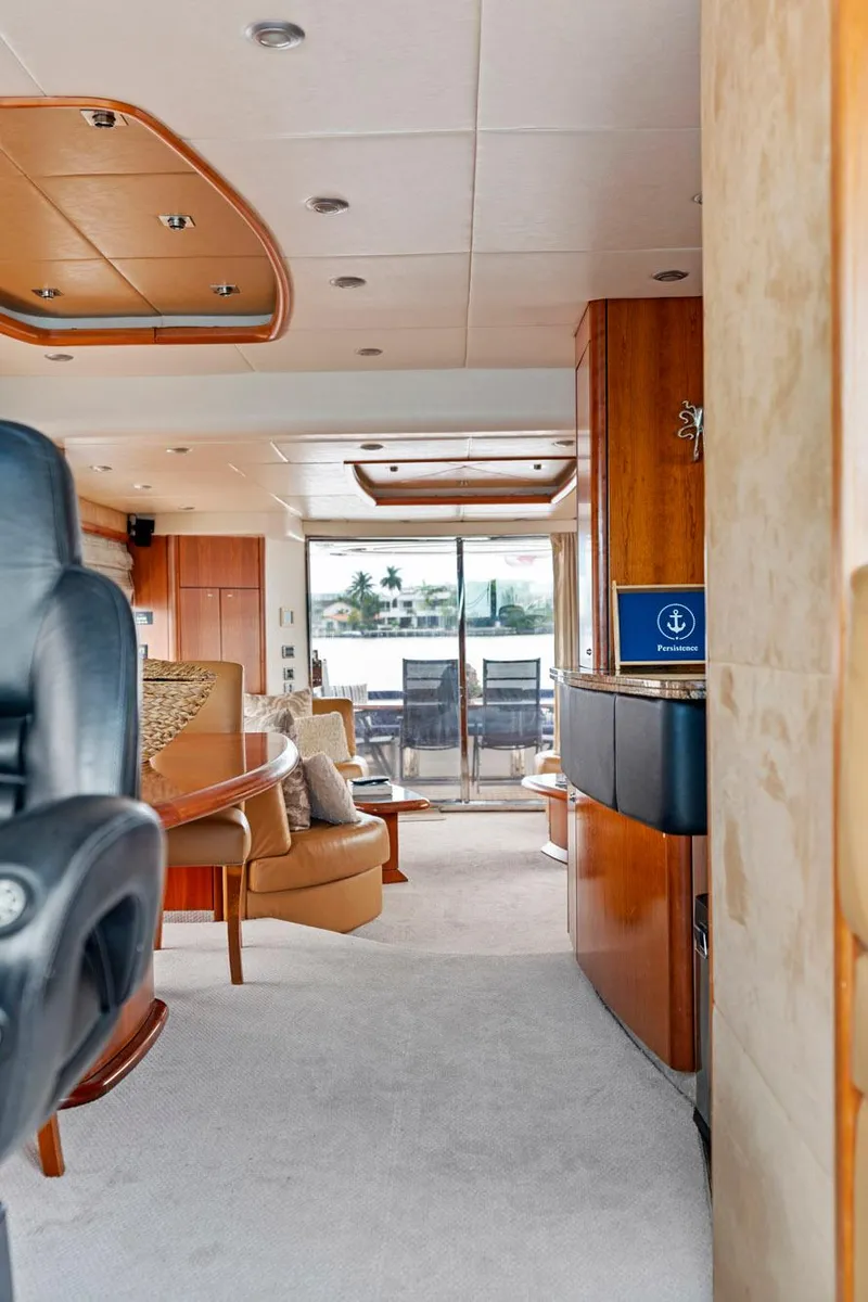 Slide: The Image of Interior of a 2006 Sunseeker 75 Yacht, featuring luxurious seating and elegant wood finishes. - 29
