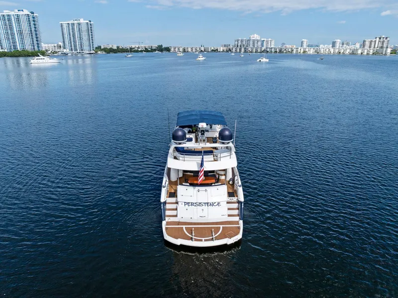 Slide: The Image of Sunseeker 75 Yacht 2006 on calm water, city skyline in background. - 3