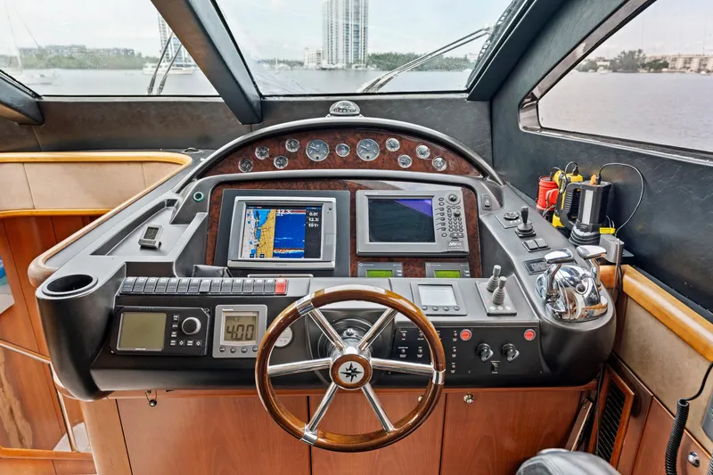 Slide: The Image of Helm of 2006 Sunseeker 75 Yacht with navigation instruments and steering wheel. - 31