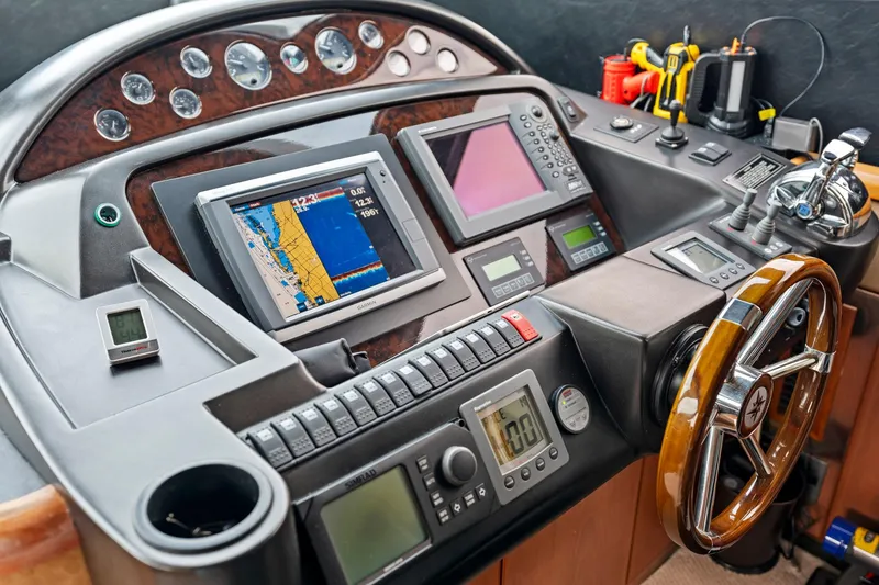 Slide: The Image of Control panel of a 2006 Sunseeker 75 Yacht with navigation screens and instruments. - 32