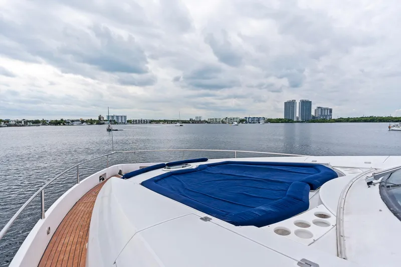 Slide: The Image of Sunseeker 75 Yacht 2006 on calm waters with cityscape in background. - 33