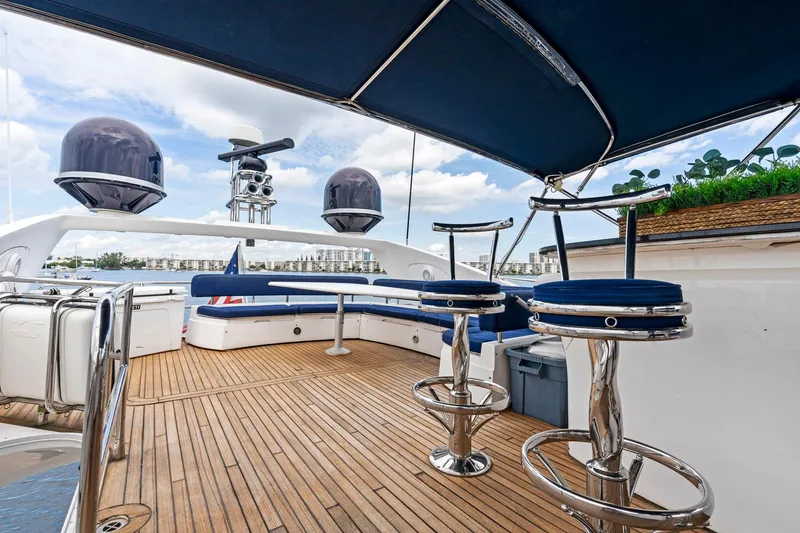 Slide: The Image of Luxurious 2006 Sunseeker 75 Yacht deck with seating and bar stools under canopy. - 35