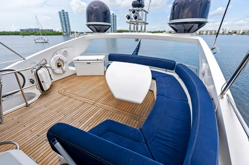Slide: The Image of Luxurious 2006 Sunseeker 75 Yacht deck with blue seating and scenic water view. - 36