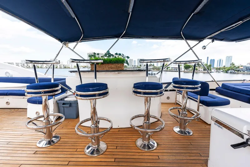 Slide: The Image of Luxurious Sunseeker 75 Yacht 2006 deck with bar stools and city skyline view. - 37
