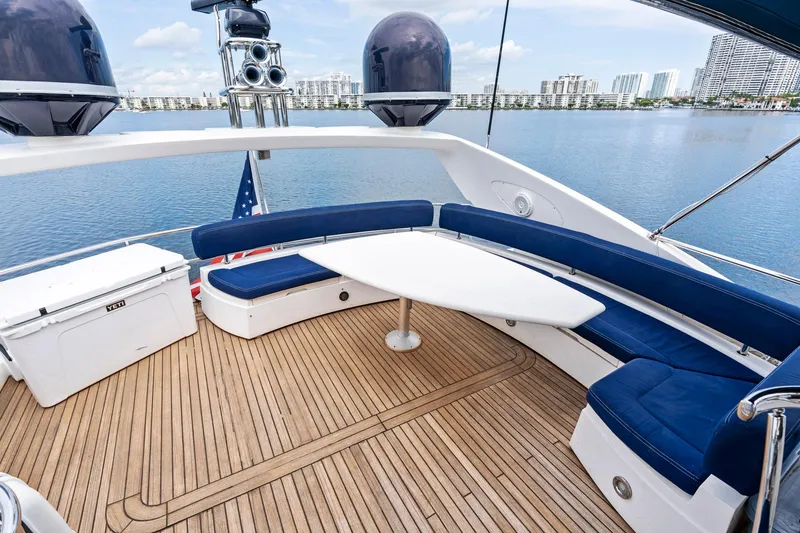 Slide: The Image of Luxurious 2006 Sunseeker 75 Yacht deck with blue seating and scenic waterfront view. - 40