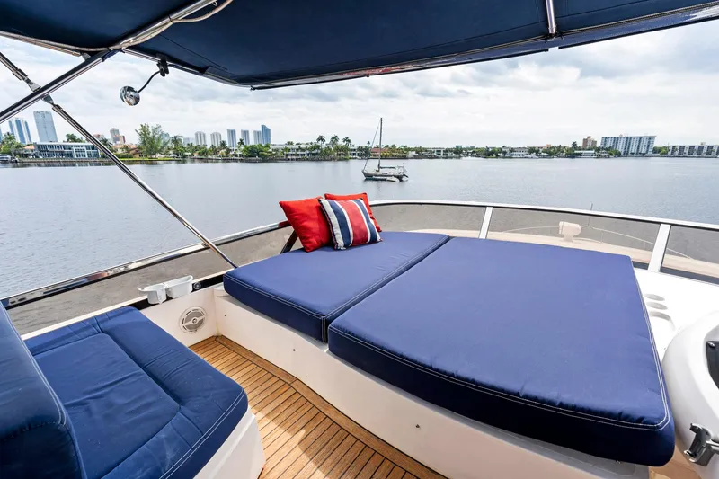 Slide: The Image of Luxurious 2006 Sunseeker 75 Yacht deck with blue seating and scenic waterfront view. - 42