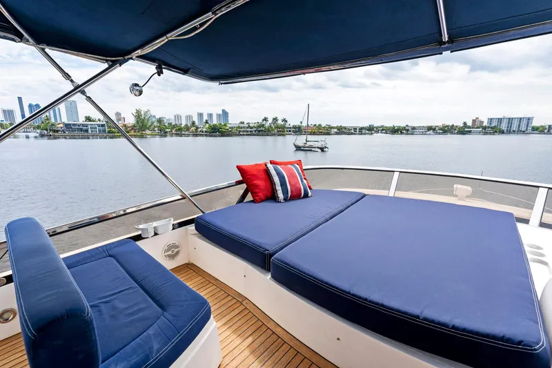 Slide: The Image of Sunseeker 75 Yacht 2006 with blue sunbathing deck, scenic waterfront view. - 43