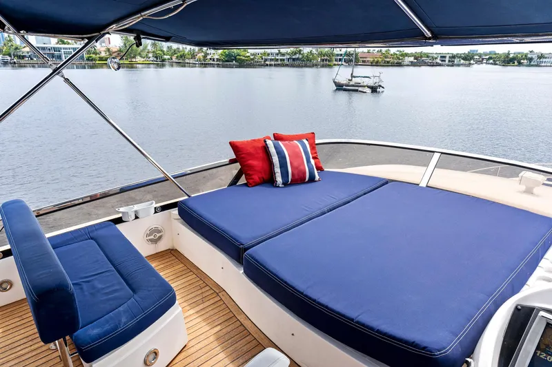 Slide: The Image of Luxurious Sunseeker 75 Yacht 2006 with blue sunbed and scenic water view. - 44