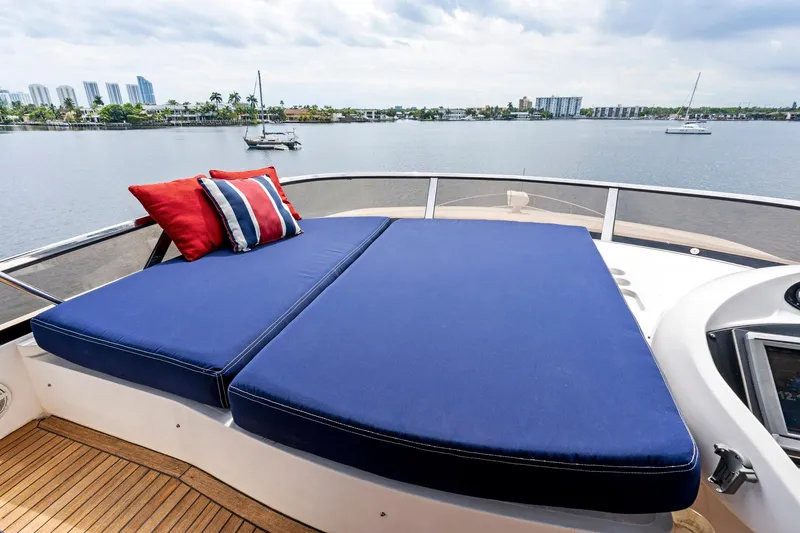 Slide: The Image of Sunseeker 75 Yacht 2006 with blue sunbed and scenic waterfront view. - 46