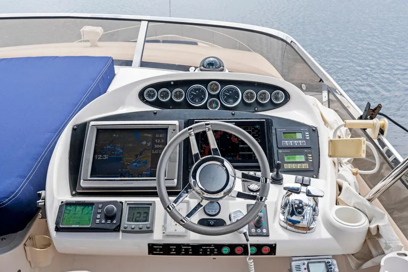 Slide: The Image of Cockpit of 2006 Sunseeker 75 Yacht with navigation instruments and steering wheel. - 48