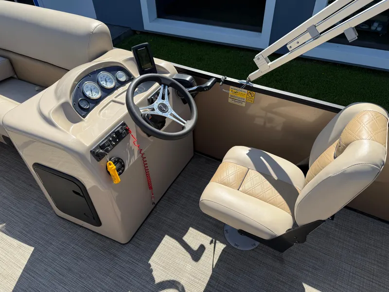 Slide: The Image of 2019 Bentley Pontoons 180 CRUISE dashboard and captain's chair, featuring steering wheel and gauges. - 13