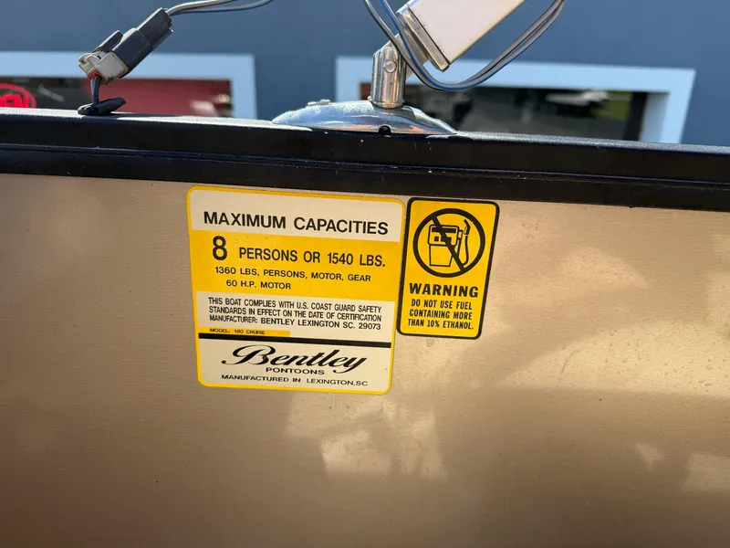 Slide: The Image of 2019 Bentley Pontoons 180 CRUISE capacity label, max 8 persons or 1540 lbs, safety warning. - 18