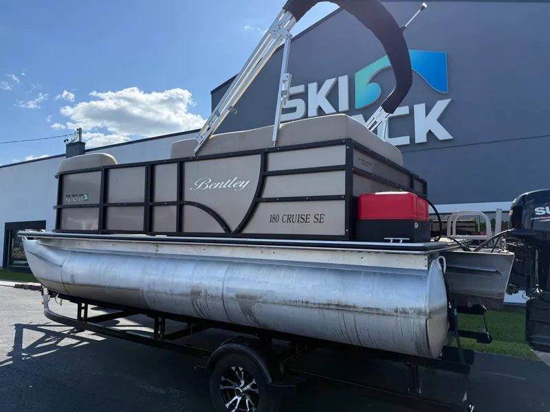 Slide: The Image of 2019 Bentley Pontoons 180 CRUISE on trailer, parked outside dealership under clear sky. - 4