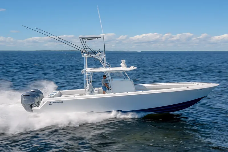 The Image of 2022 Contender 39 ST boat cruising on open water under clear skies. - 0