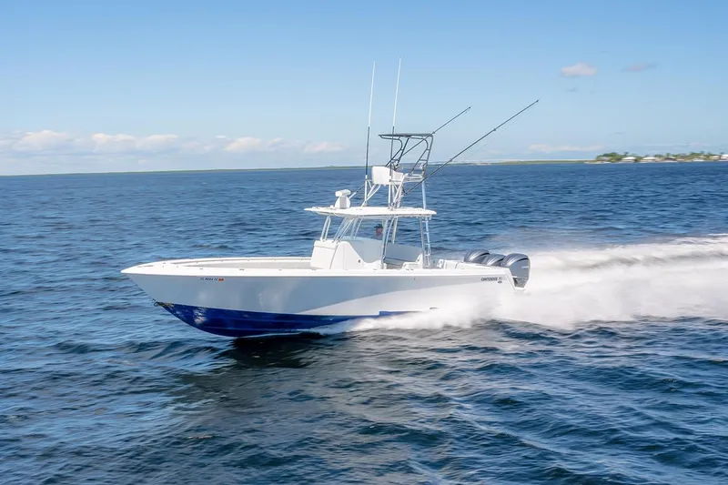 Slide: The Image of 2022 Contender 39 ST boat cruising on open water under clear blue skies. - 1