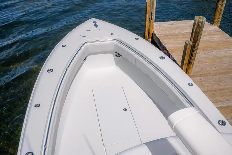 Slide: The Image of 2022 Contender 39 ST boat docked on clear water, showcasing sleek design and spacious deck. - 10