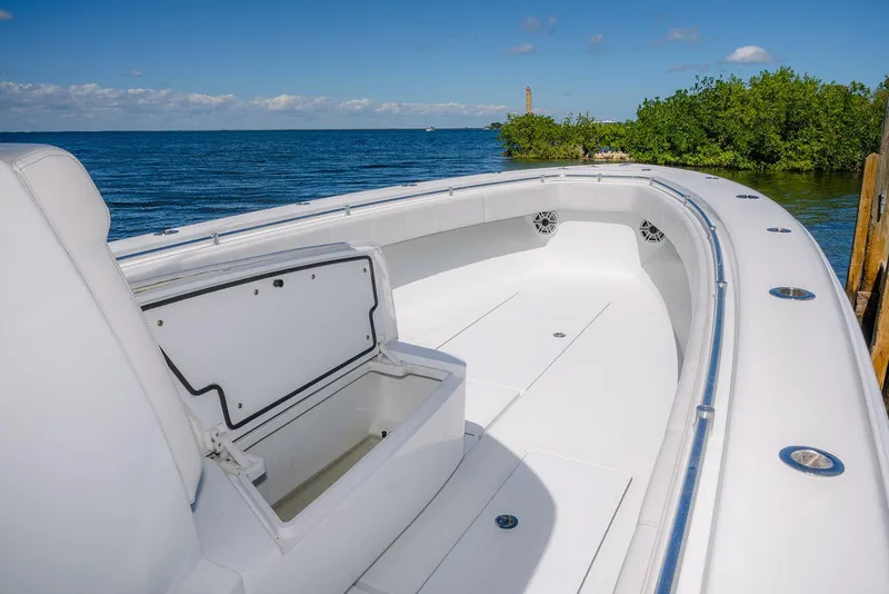 Slide: The Image of 2022 Contender 39 ST boat interior with open storage, ocean view, and clear sky. - 13