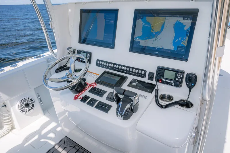 Slide: The Image of 2022 Contender 39 ST boat helm with dual navigation screens and control panel. - 18