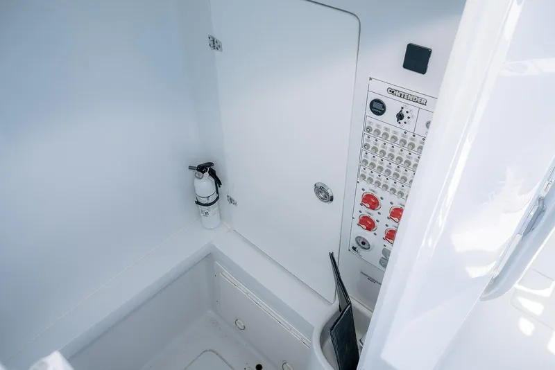 Slide: The Image of 2022 Contender 39 ST boat interior with control panel and fire extinguisher. - 20