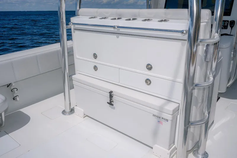 Slide: The Image of 2022 Contender 39 ST boat interior with storage compartments and ocean view. - 21