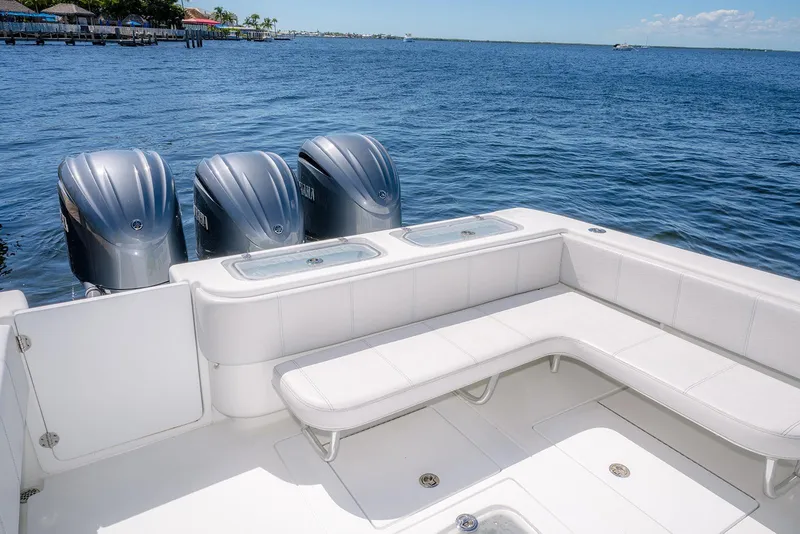 Slide: The Image of 2022 Contender 39 ST boat with triple outboard engines on a calm sea. - 24