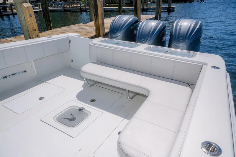 Slide: The Image of 2022 Contender 39 ST boat interior with seating and triple outboard engines. - 25