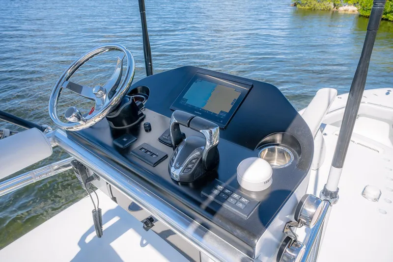 Slide: The Image of 2022 Contender 39 ST boat dashboard with steering wheel, navigation screen, and controls. - 28