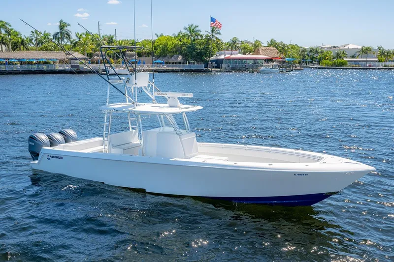 Slide: The Image of 2022 Contender 39 ST boat on water, featuring triple outboard engines. - 7