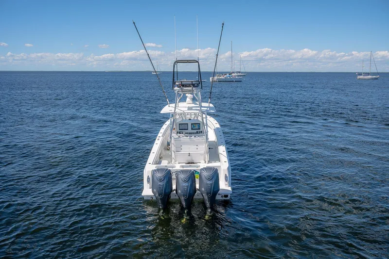 Slide: The Image of 2022 Contender 39 ST boat with triple engines on open water. - 8