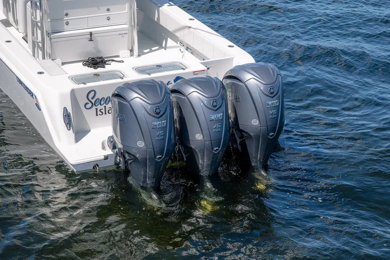 Slide: The Image of 2022 Contender 39 ST boat with triple Yamaha 300 V6 outboard engines on water. - 9