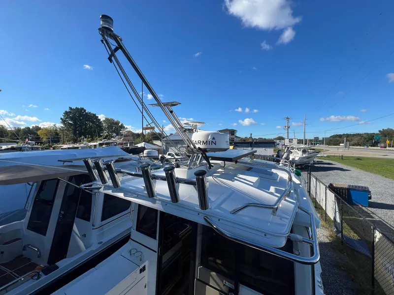 Slide: The Image of 2016 Cutwater C28 boat with radar and rod holders under a clear blue sky. - 13