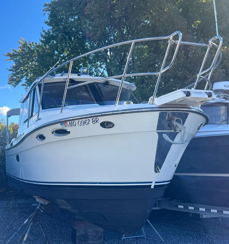 Slide: The Image of 2016 Cutwater C28 boat on dry dock, surrounded by trees and other vessels. - 2