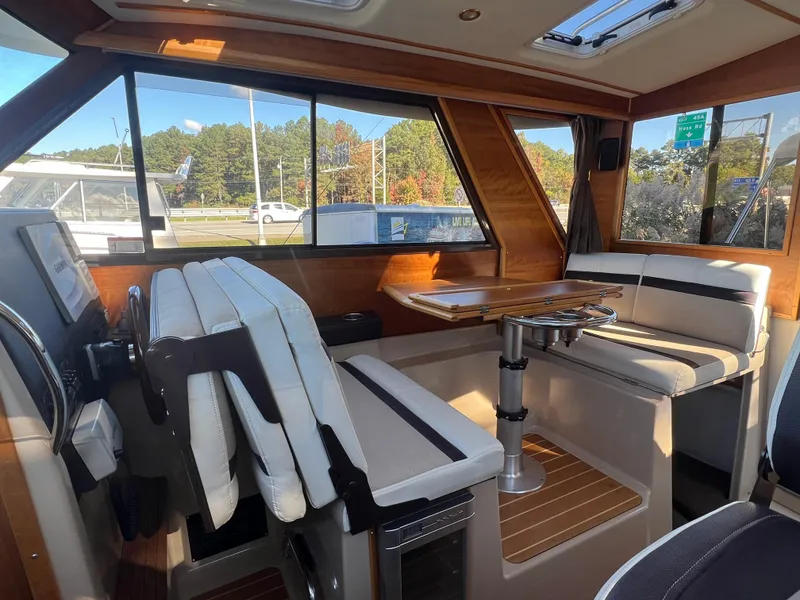 Slide: The Image of Interior of a 2016 Cutwater C28 boat with seating and table. - 23