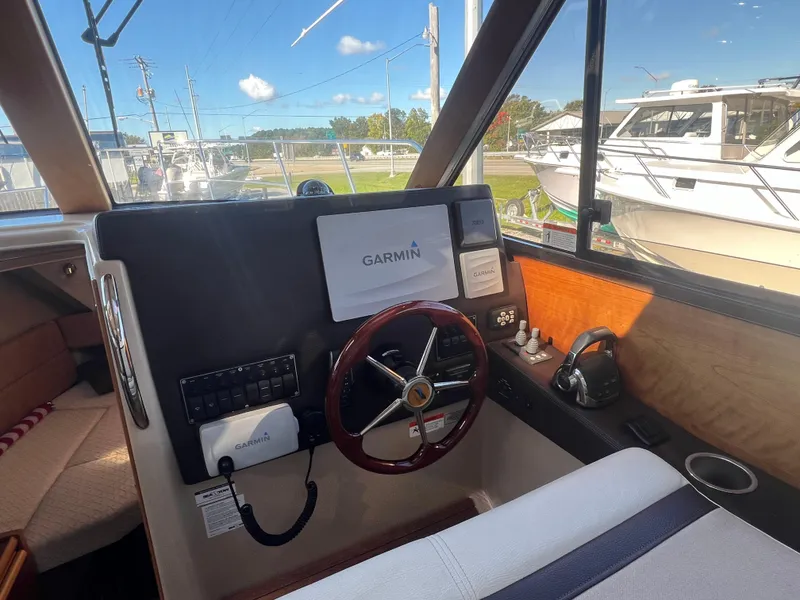 Slide: The Image of Helm of 2016 Cutwater C28 boat with Garmin navigation system and steering wheel. - 24