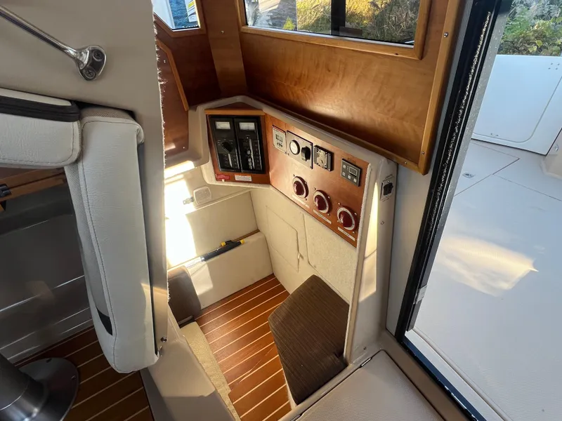 Slide: The Image of Interior view of 2016 Cutwater C28 boat, featuring control panel and seating area. - 27